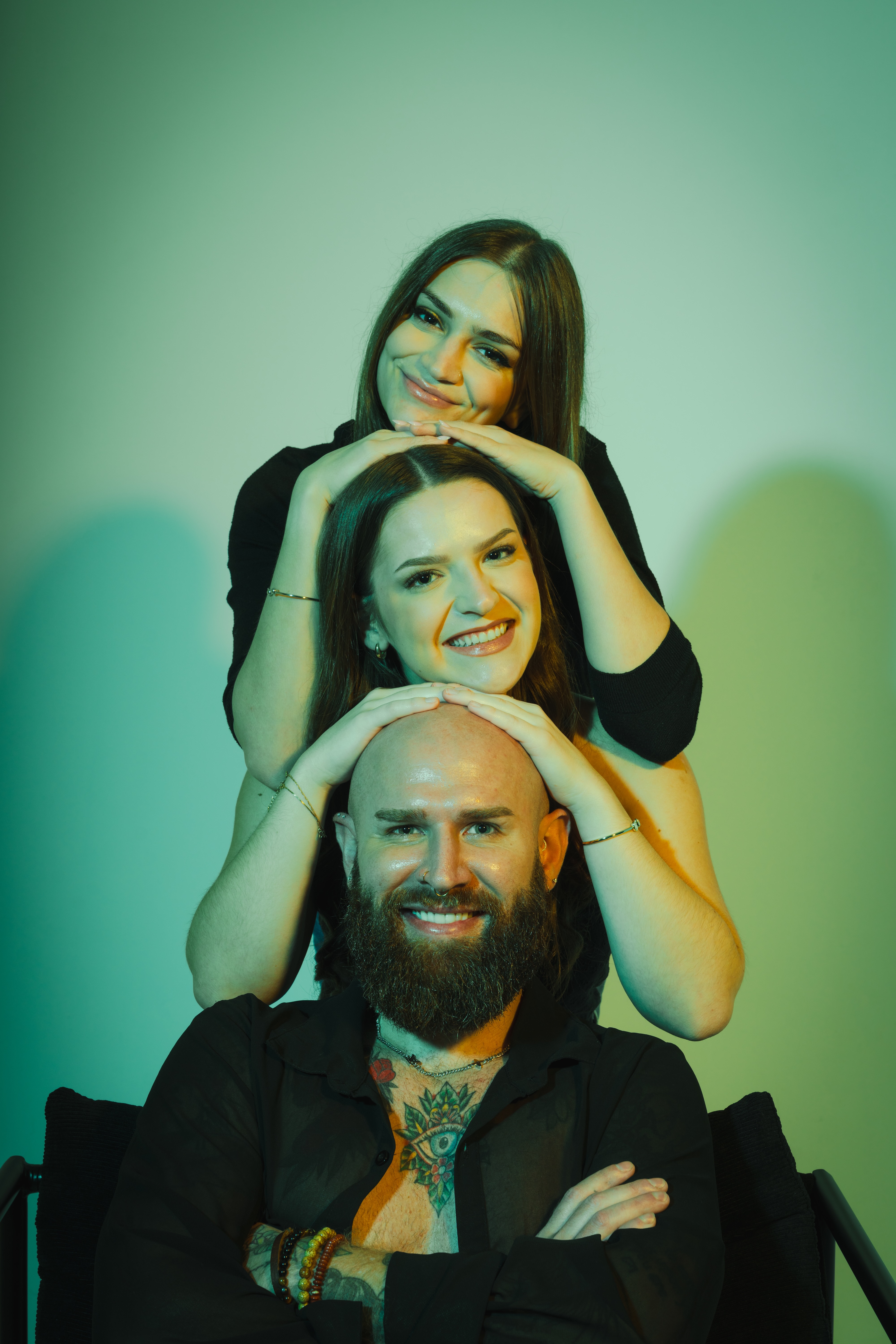 The Redavfined Aesthetics team stacked together, smiling, in the studio